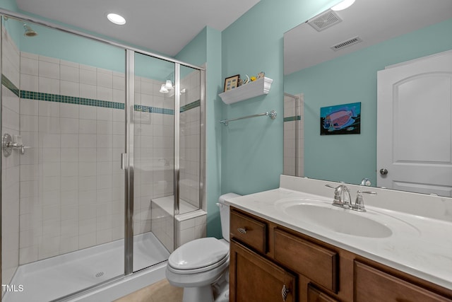 bathroom featuring toilet, an enclosed shower, tile patterned floors, and vanity