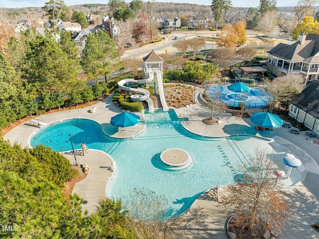 view of pool featuring a water slide and a patio area