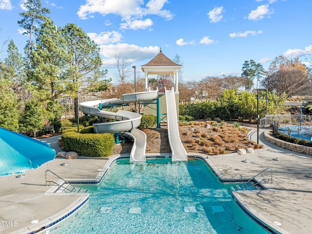 view of swimming pool featuring a water slide