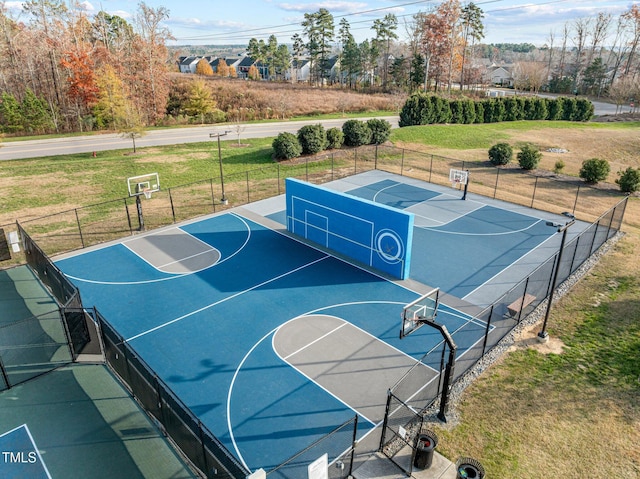 view of basketball court featuring a yard