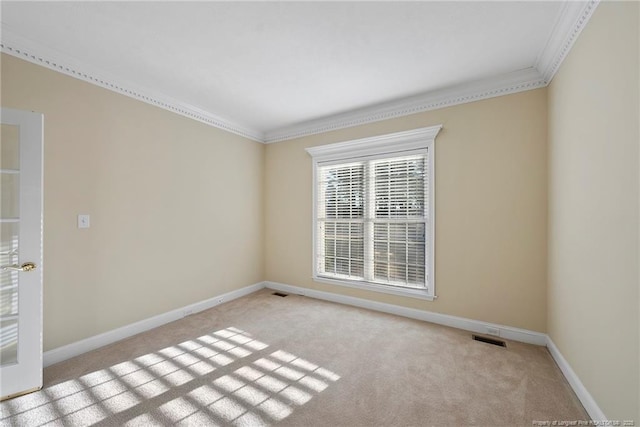 carpeted spare room featuring ornamental molding