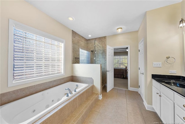 bathroom featuring shower with separate bathtub, vanity, and tile patterned floors