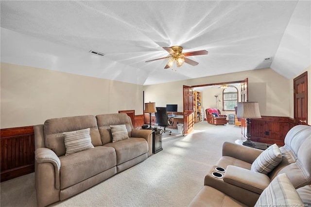 living room featuring ceiling fan, carpet, and lofted ceiling