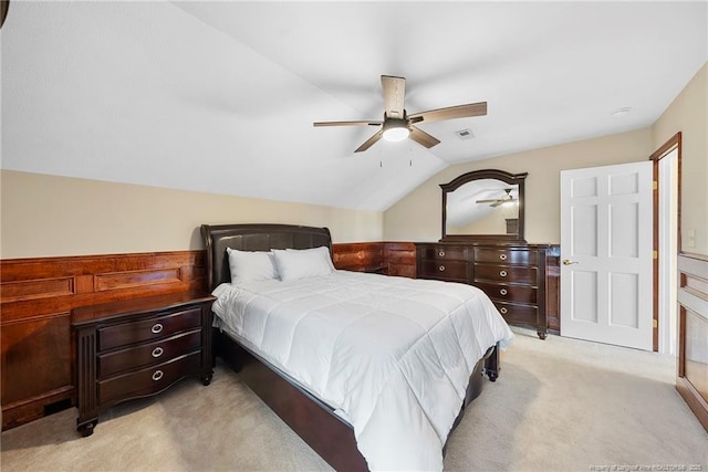 bedroom featuring light colored carpet, vaulted ceiling, and ceiling fan