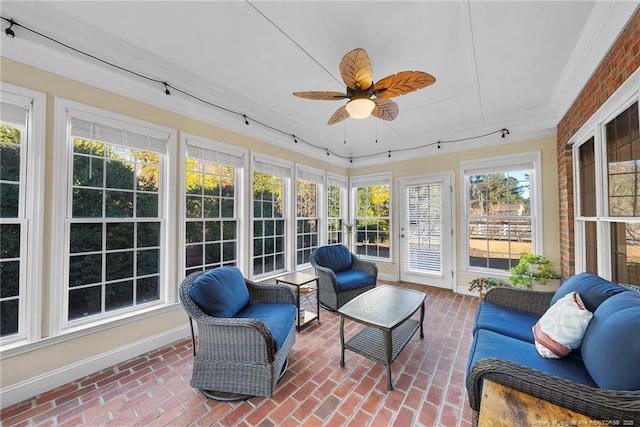 sunroom / solarium featuring ceiling fan