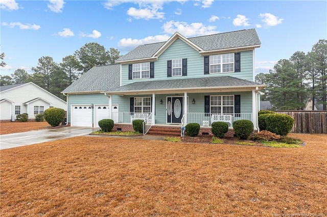 view of front facade with a garage, covered porch, and a front lawn