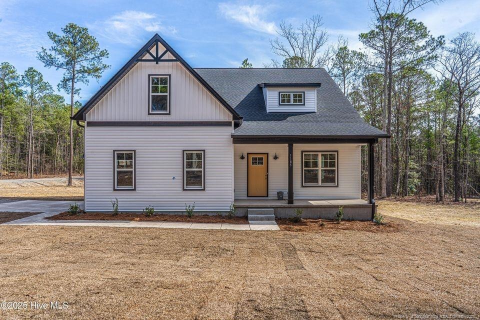 view of front of property featuring a porch and a shingled roof