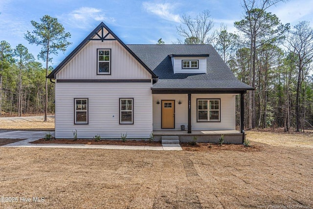 view of front of property featuring a porch and a shingled roof