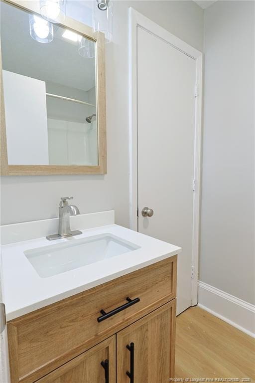 bathroom with hardwood / wood-style floors and vanity