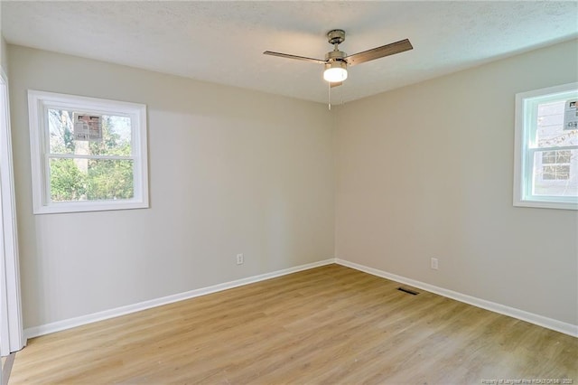 spare room featuring ceiling fan and light hardwood / wood-style flooring