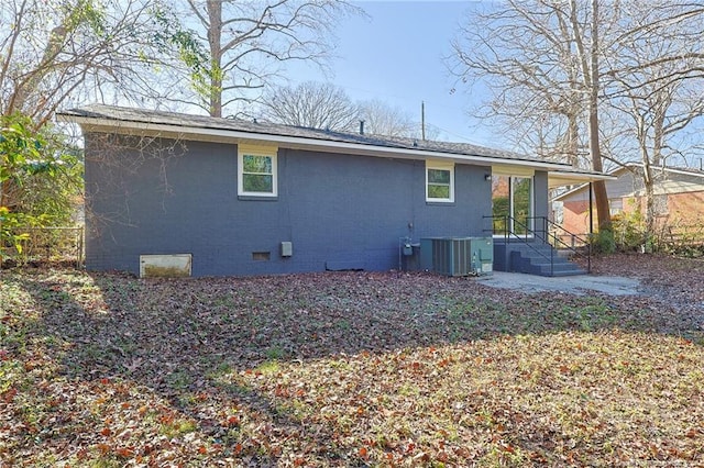 rear view of property with cooling unit