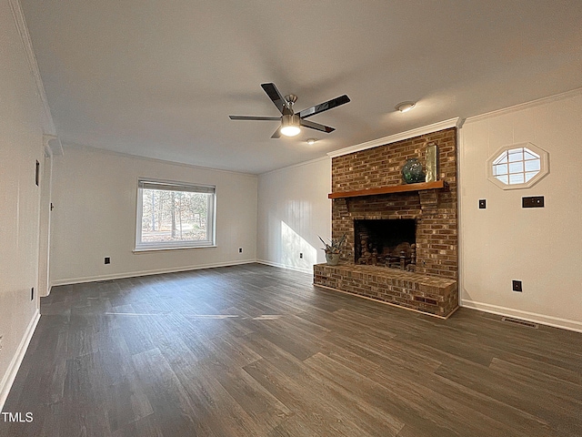 unfurnished living room featuring crown molding, a fireplace, dark hardwood / wood-style floors, and ceiling fan