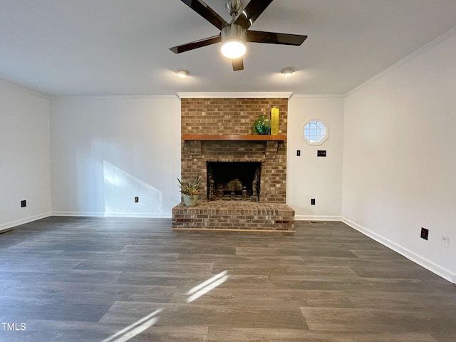 unfurnished living room with dark hardwood / wood-style flooring, a brick fireplace, ornamental molding, and ceiling fan