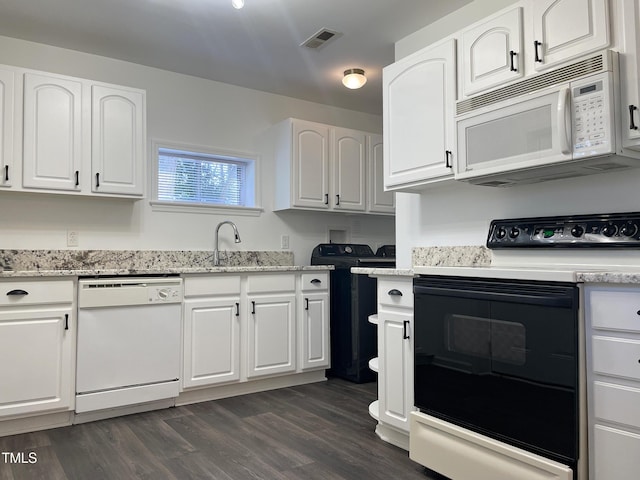 kitchen featuring white cabinetry, white appliances, dark hardwood / wood-style floors, and sink