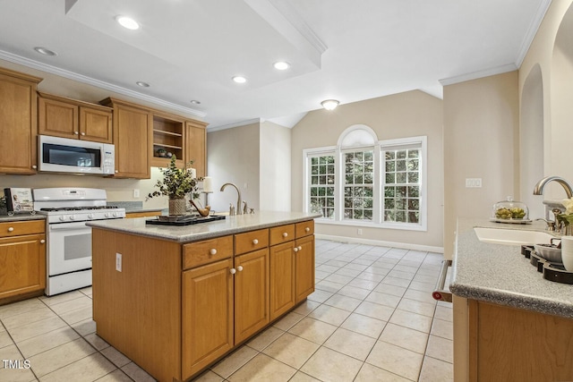 kitchen featuring sink, a center island with sink, white appliances, and crown molding