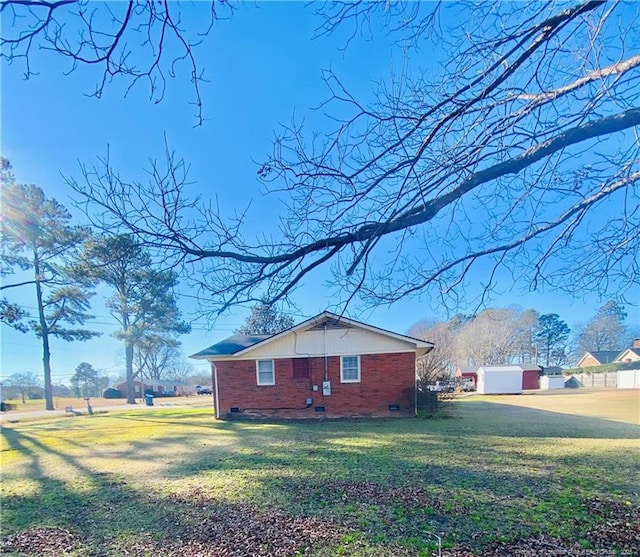 view of side of home featuring a lawn