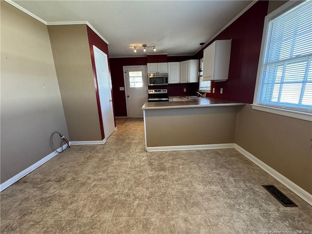 kitchen featuring sink, crown molding, white cabinetry, stainless steel appliances, and kitchen peninsula