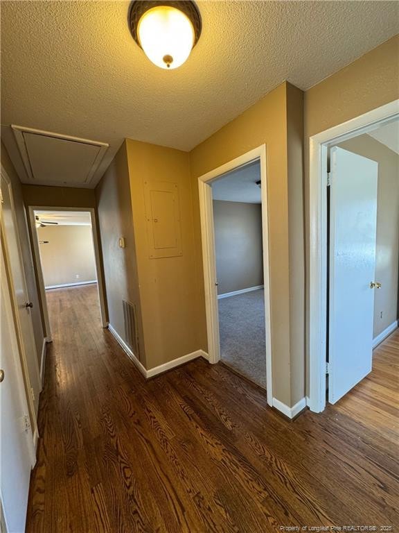 corridor featuring dark hardwood / wood-style floors and a textured ceiling