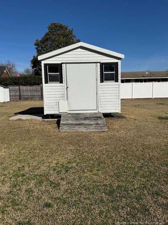 view of outbuilding with a lawn