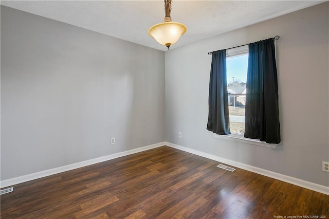 empty room featuring dark hardwood / wood-style floors