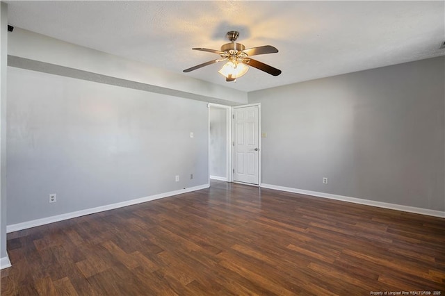 spare room with ceiling fan and dark hardwood / wood-style flooring