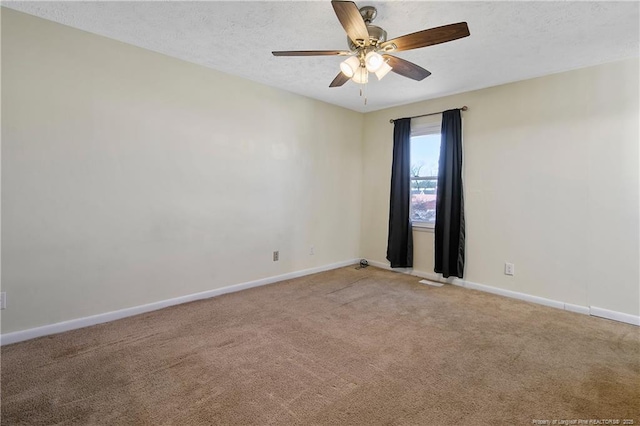 carpeted empty room featuring ceiling fan and a textured ceiling