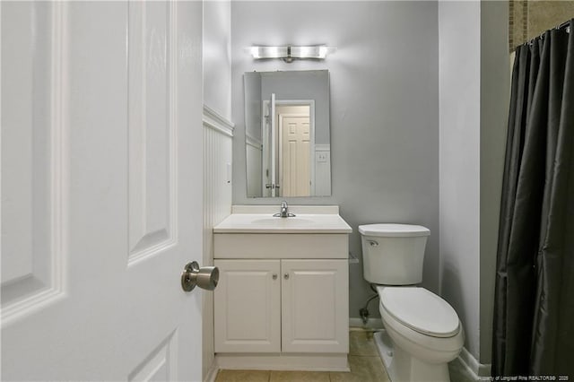 bathroom featuring tile patterned flooring, vanity, and toilet