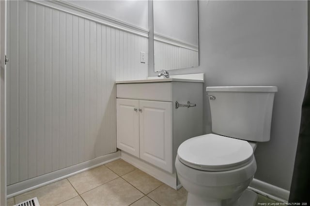 bathroom with tile patterned flooring, vanity, and toilet