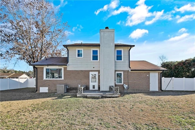 back of house with a yard, a patio, and central AC