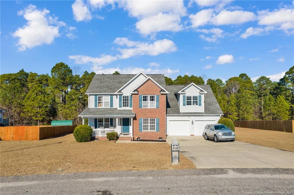 view of front of home with covered porch and a garage