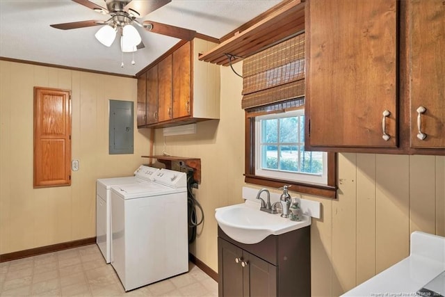 clothes washing area with ceiling fan, sink, cabinets, separate washer and dryer, and electric panel