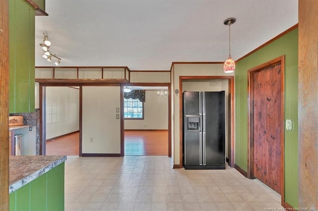 kitchen featuring ornamental molding, decorative light fixtures, black refrigerator with ice dispenser, and green cabinets