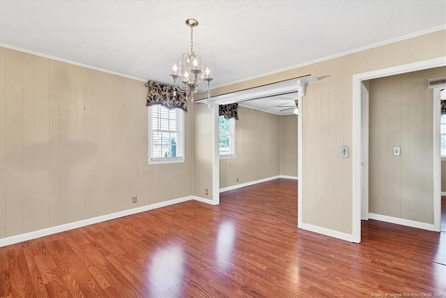 spare room with hardwood / wood-style floors, ceiling fan with notable chandelier, and ornamental molding