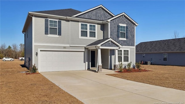 craftsman house with a garage and central air condition unit