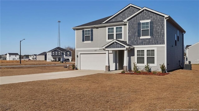 view of front of home with central AC unit and a garage