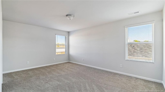 spare room featuring carpet