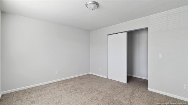 unfurnished bedroom featuring a closet and carpet floors