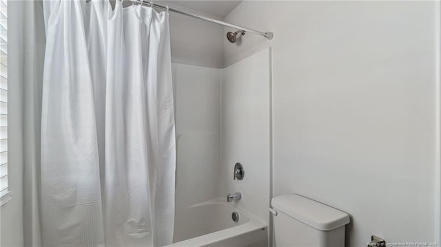 bathroom with toilet and shower / tub combo with curtain