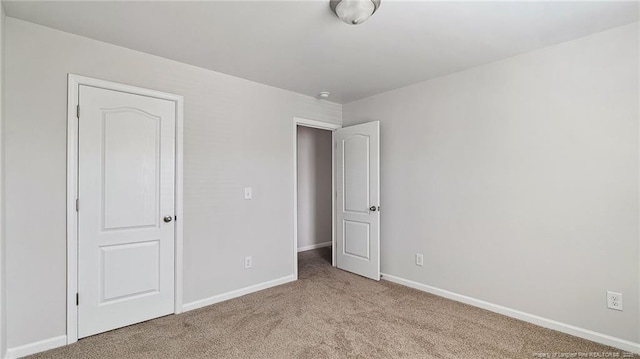 unfurnished bedroom with light colored carpet