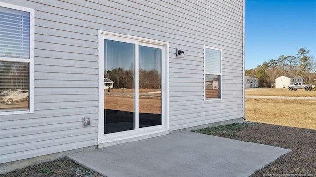 property entrance featuring a patio area