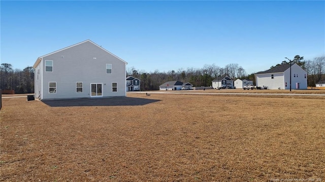 view of yard with central air condition unit and a patio