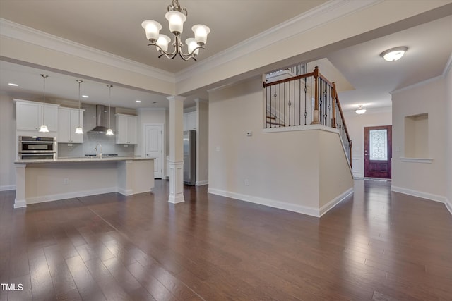 unfurnished living room featuring dark hardwood / wood-style flooring, crown molding, and a notable chandelier