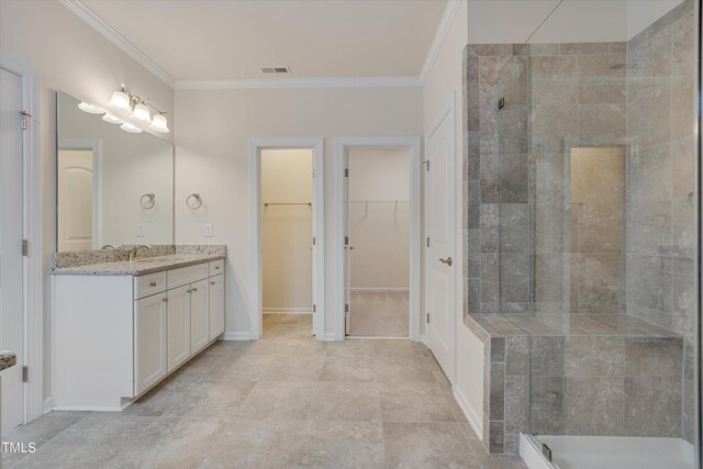 bathroom featuring crown molding, a shower with door, and vanity