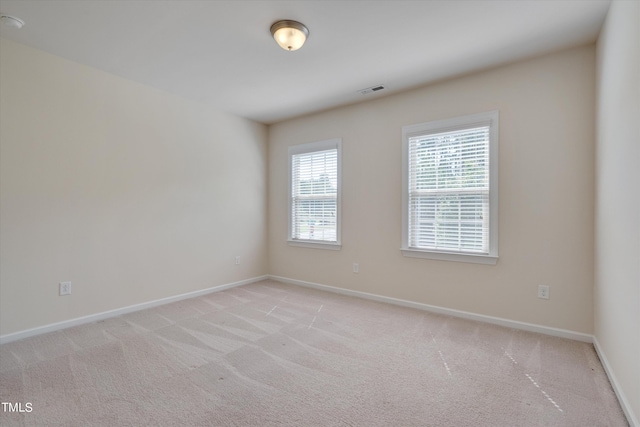 unfurnished room with light colored carpet