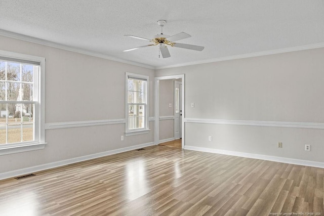 unfurnished room with crown molding, ceiling fan, light hardwood / wood-style floors, and a textured ceiling