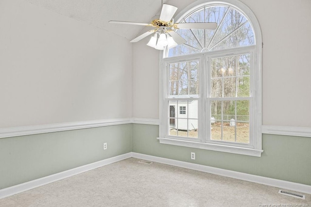 empty room with ceiling fan and a textured ceiling