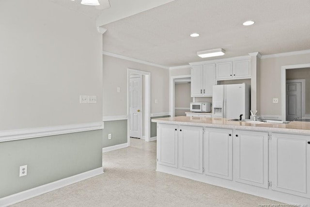 kitchen with white cabinets, white appliances, crown molding, and sink