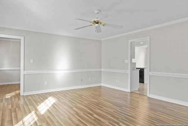 empty room featuring crown molding, ceiling fan, a textured ceiling, and light wood-type flooring