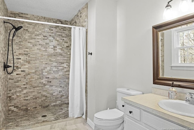 bathroom featuring toilet, a textured ceiling, vanity, and a shower with curtain