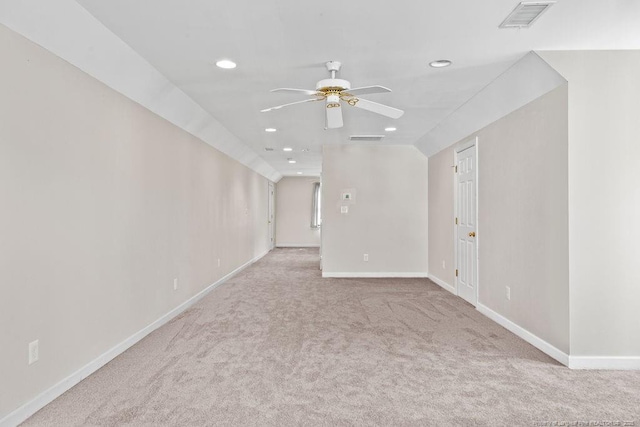 carpeted empty room with ceiling fan and lofted ceiling